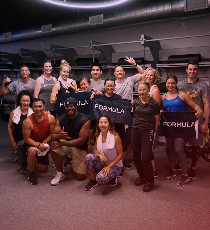 fitness group posing after a fire cardio studio exercise class