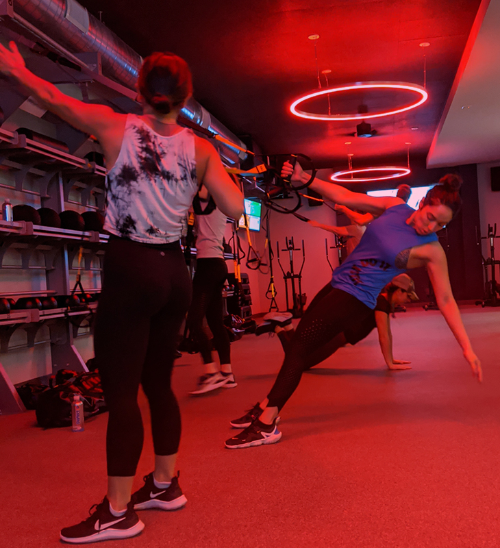 woman doing exercise using trx suspension trainer