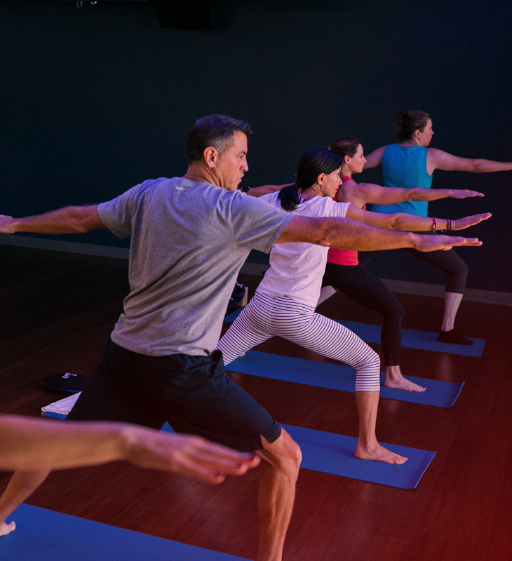 yoga group exercise class in warrior pose